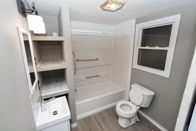 317 S Miami Ave, Xenia, OH 45385 - bathroom with a textured ceiling, toilet, wood finished floors,  shower combination, and baseboards