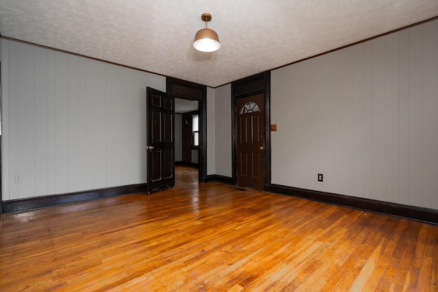 317 S Miami Ave, Xenia, OH 45385 - spare room with wood-type flooring, a textured ceiling, baseboards, and ornamental molding