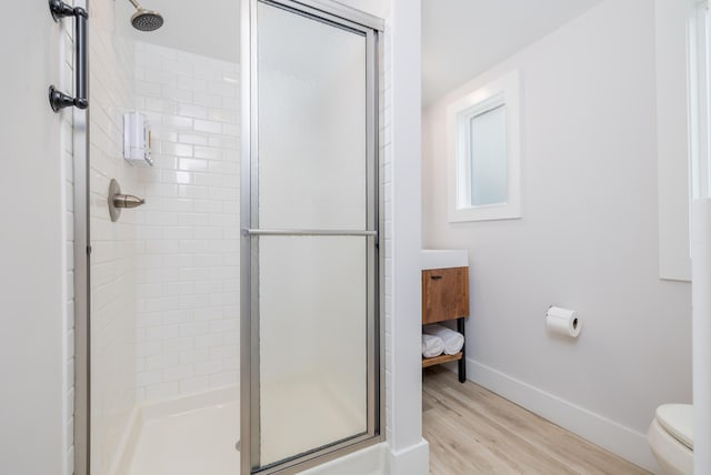 7925 Hickory Ave, Russells Point, OH 43348 - full bath with a stall shower, baseboards, wood finished floors, toilet, and vanity