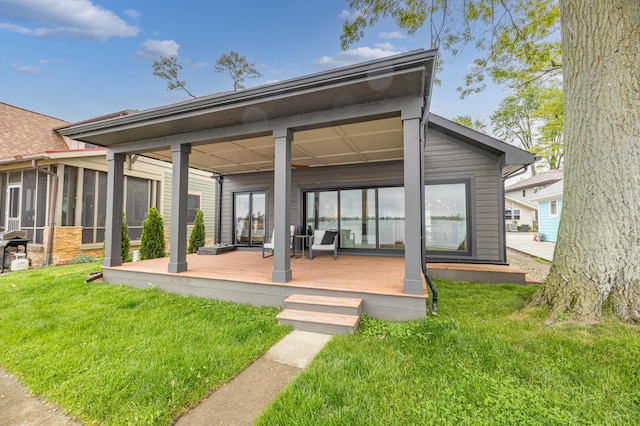 7925 Hickory Ave, Russells Point, OH 43348 - rear view of property featuring a yard, a deck, and a sunroom