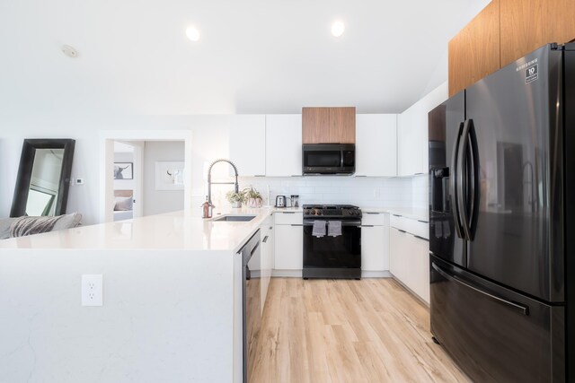 7925 Hickory Ave, Russells Point, OH 43348 - kitchen with fridge with ice dispenser, a sink, range with gas cooktop, a peninsula, and decorative backsplash