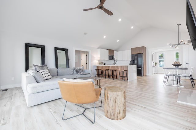 7925 Hickory Ave, Russells Point, OH 43348 - living room with high vaulted ceiling, a chandelier, a ceiling fan, light wood-type flooring, and recessed lighting