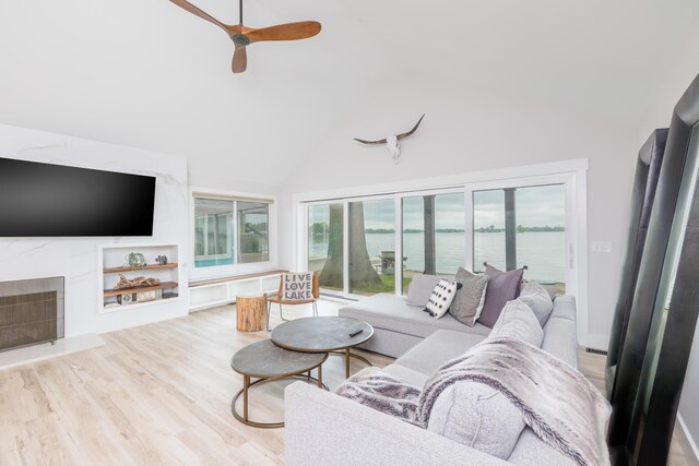 7925 Hickory Ave, Russells Point, OH 43348 - living room with plenty of natural light, high vaulted ceiling, ceiling fan, wood finished floors, and a water view