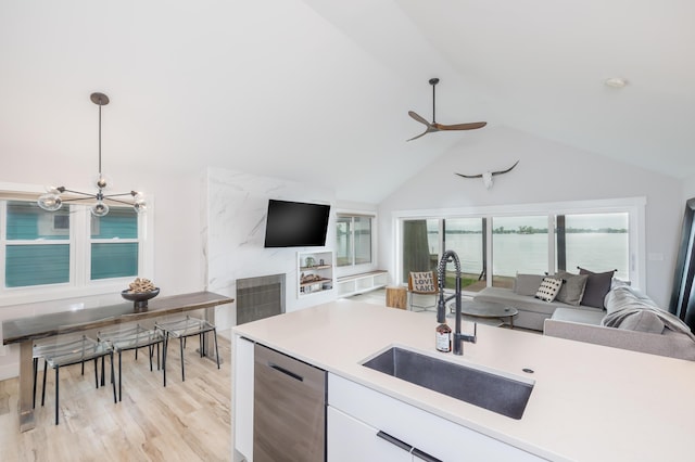 7925 Hickory Ave, Russells Point, OH 43348 - kitchen featuring a sink, open floor plan, dishwasher, a ceiling fan, and lofted ceiling