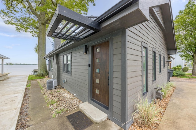 7925 Hickory Ave, Russells Point, OH 43348 - doorway to property with a water view and central air condition unit