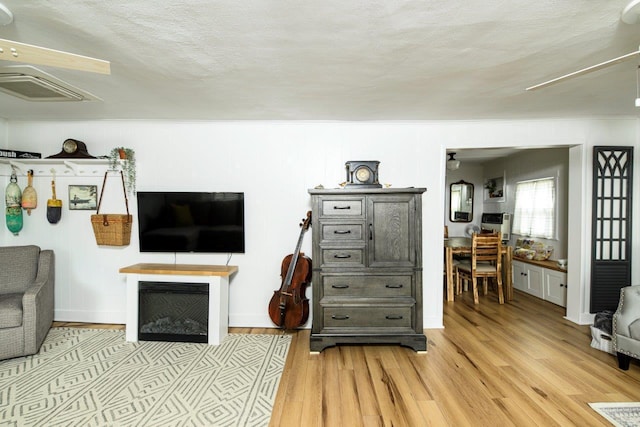 9887 Forest St, Lakeview, OH 43331 - living room with attic access, light wood-style floors, and a textured ceiling