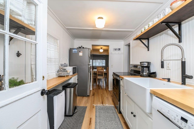 9887 Forest St, Lakeview, OH 43331 - kitchen featuring stainless steel appliances, a sink, ornamental molding, light wood finished floors, and wood counters