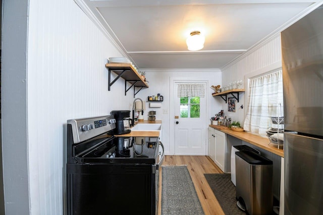 9887 Forest St, Lakeview, OH 43331 - kitchen with stainless steel appliances, open shelves, a sink, butcher block counters, and ornamental molding