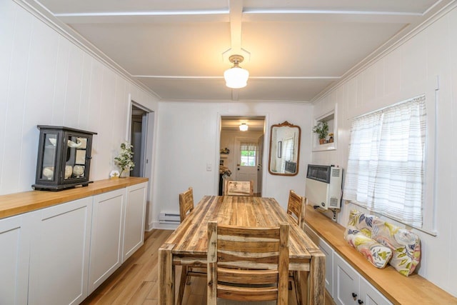 9887 Forest St, Lakeview, OH 43331 - dining area featuring crown molding, light wood-style flooring, heating unit, and a baseboard heating unit