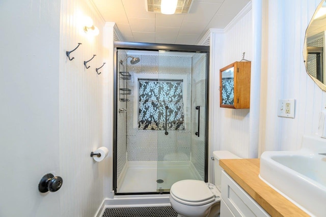 9887 Forest St, Lakeview, OH 43331 - bathroom featuring a shower stall, toilet, vanity, and ornamental molding