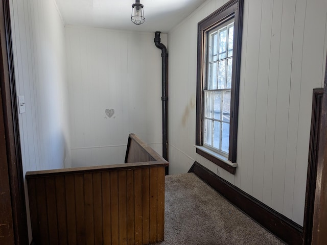 corridor with plenty of natural light and carpet