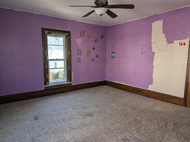 carpeted empty room featuring ceiling fan