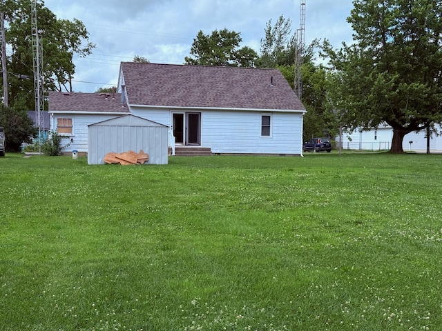 7188 Clark Dr, Russells Point, OH 43348 - back of property with entry steps, a lawn, crawl space, and roof with shingles