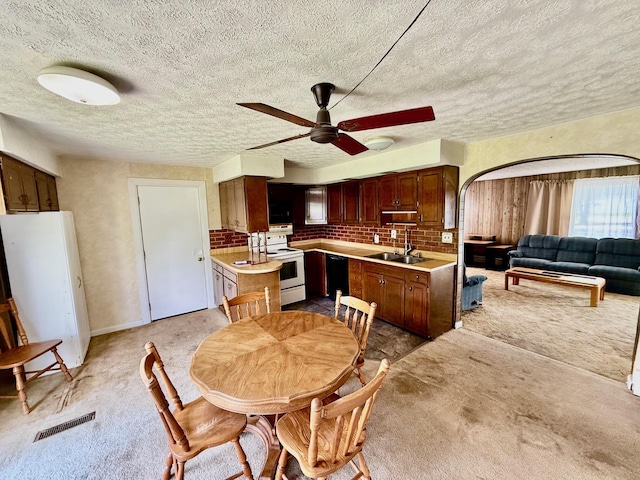 7188 Clark Dr, Russells Point, OH 43348 - dining area with ceiling fan, light colored carpet, arched walkways, and a textured ceiling