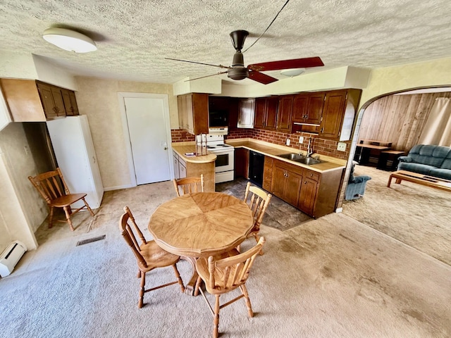 7188 Clark Dr, Russells Point, OH 43348 - kitchen with white electric range oven, light countertops, ceiling fan, black dishwasher, and light carpet