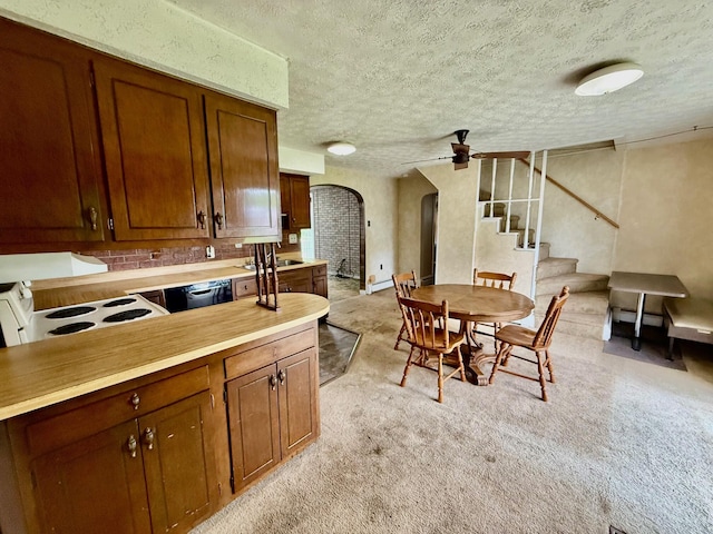 7188 Clark Dr, Russells Point, OH 43348 - dining room featuring arched walkways, a textured ceiling, ceiling fan, stairway, and light colored carpet