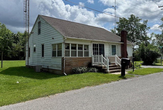 7188 Clark Dr, Russells Point, OH 43348 - bungalow-style home featuring a chimney, a front lawn, and roof with shingles