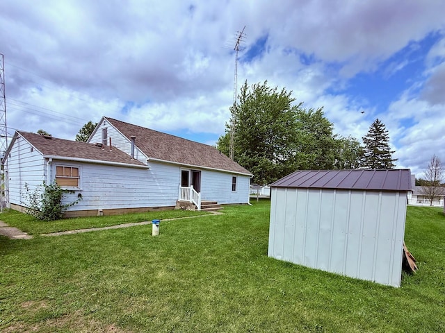 7188 Clark Dr, Russells Point, OH 43348 - rear view of house featuring a storage unit and a lawn