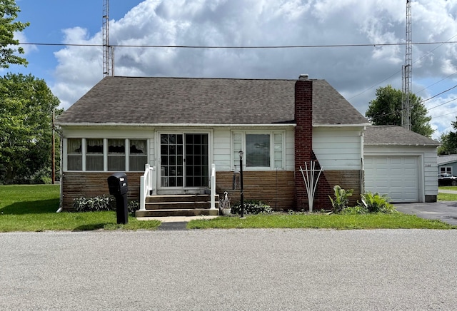 7188 Clark Dr, Russells Point, OH 43348 - view of front of home with a chimney, a garage, driveway, a shingled roof, and stone siding