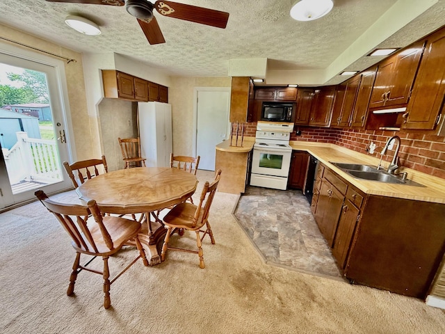 7188 Clark Dr, Russells Point, OH 43348 - kitchen with black appliances, a textured ceiling, light carpet, and light countertops