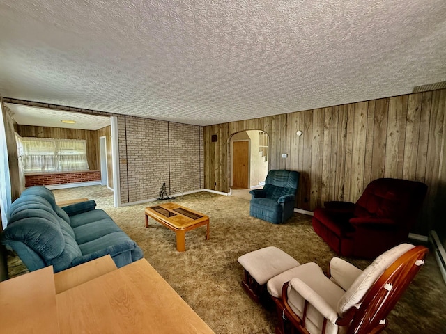 7188 Clark Dr, Russells Point, OH 43348 - living room featuring arched walkways, wooden walls, carpet floors, and a textured ceiling