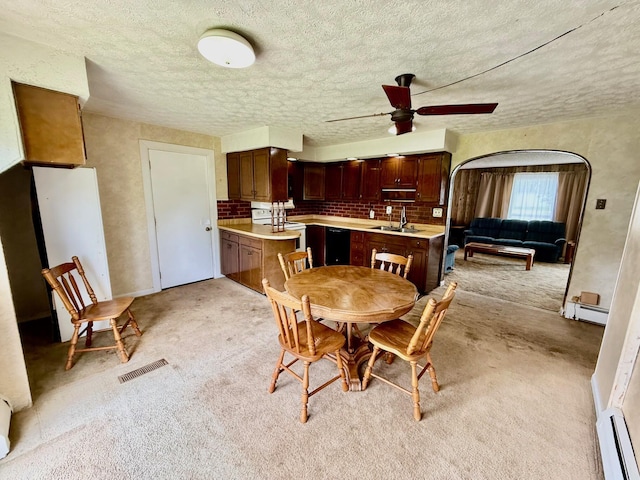 7188 Clark Dr, Russells Point, OH 43348 - dining room with light colored carpet, a ceiling fan, a baseboard radiator, and a textured ceiling