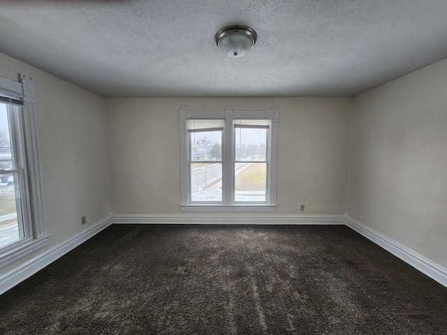 127 N Sycamore St, Union City, OH 45390 - spare room with dark carpet, a textured ceiling, and baseboards