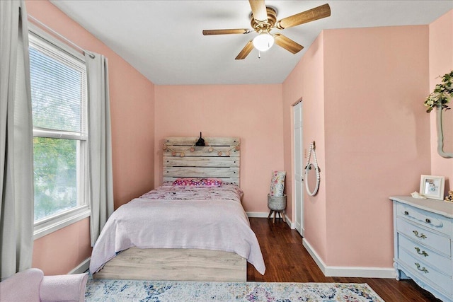 bedroom with baseboards, a ceiling fan, and dark wood-style floors
