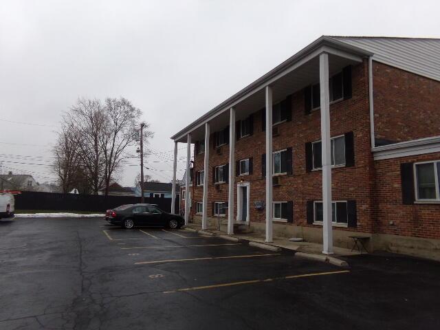 view of building exterior featuring uncovered parking