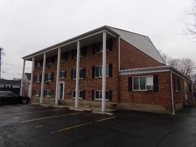 view of building exterior with uncovered parking