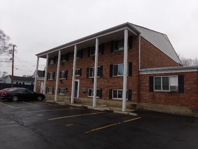 view of building exterior featuring uncovered parking