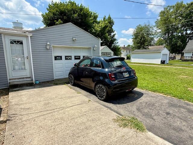 271 N Ludlow St, Covington, OH 45318 - garage with asphalt driveway