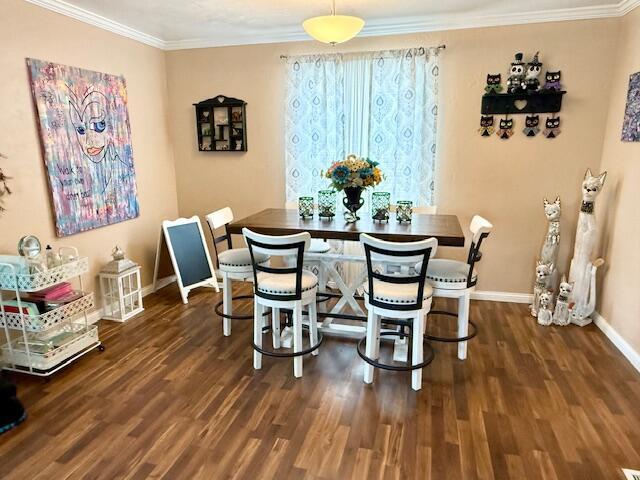 271 N Ludlow St, Covington, OH 45318 - dining space featuring wood finished floors and crown molding