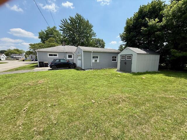 271 N Ludlow St, Covington, OH 45318 - back of property with a lawn and a storage unit