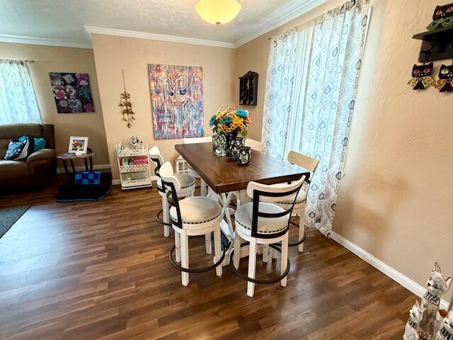 271 N Ludlow St, Covington, OH 45318 - dining room featuring dark wood-style flooring and crown molding