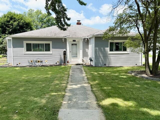 271 N Ludlow St, Covington, OH 45318 - bungalow-style house with a chimney and a front lawn