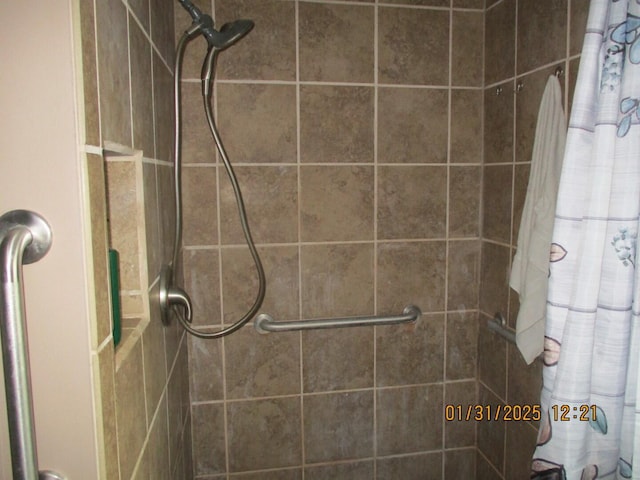 bathroom with tiled shower