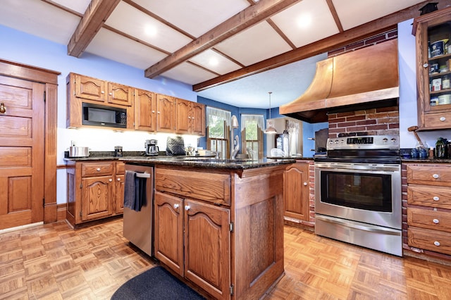 103 N Boggs St, De Graff, OH 43318 - kitchen featuring appliances with stainless steel finishes, a kitchen island, brown cabinets, beamed ceiling, and pendant lighting