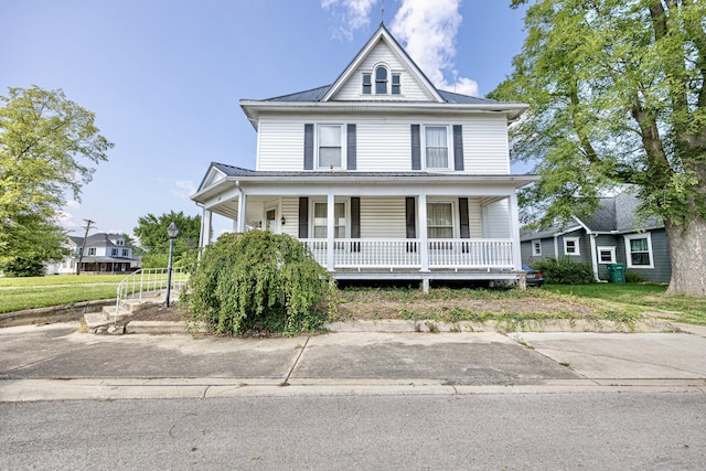 103 N Boggs St, De Graff, OH 43318 - view of front facade featuring covered porch and a metal roof