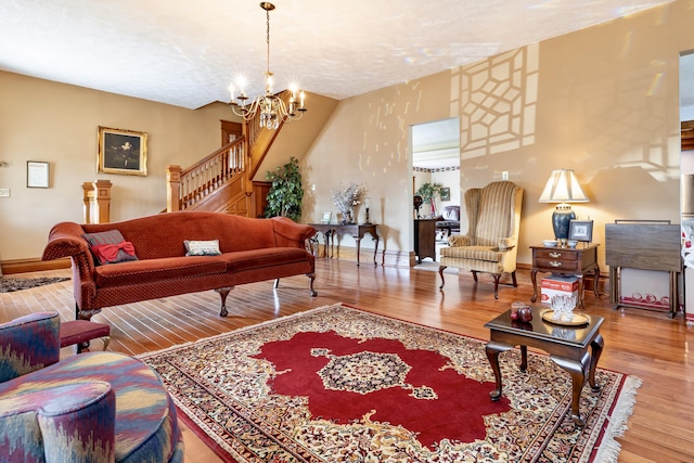 103 N Boggs St, De Graff, OH 43318 - living area featuring wood finished floors, a chandelier, and stairway