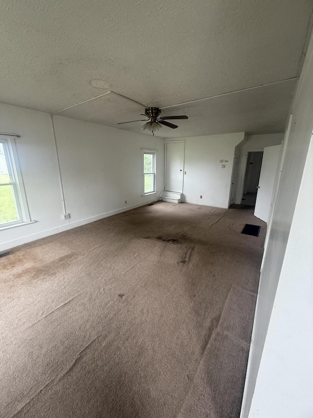 115 Vine St, Ludlow Falls, OH 45339 - carpeted empty room with a textured ceiling and ceiling fan