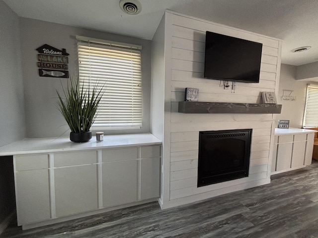 7824 Maple St, Russells Point, OH 43348 - unfurnished living room with a fireplace and dark wood-style floors