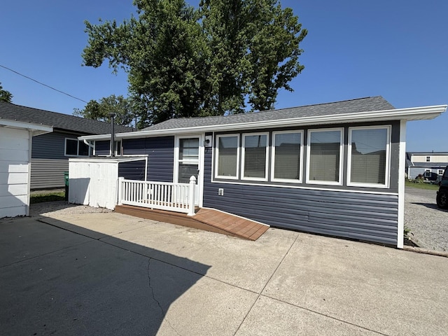 7824 Maple St, Russells Point, OH 43348 - back of house featuring a patio and a shingled roof