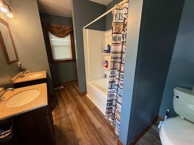 612 W Spring St, Saint Marys, OH 45885 - full bath with double vanity, toilet, wood finished floors, shower / tub combo, and baseboards