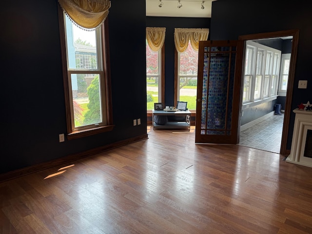 612 W Spring St, Saint Marys, OH 45885 - spare room featuring wood finished floors, baseboards, and track lighting