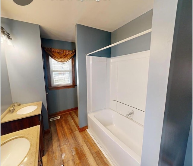 612 W Spring St, Saint Marys, OH 45885 - full bath with hardwood / wood-style floors, vanity, bathing tub / shower combination, and baseboards