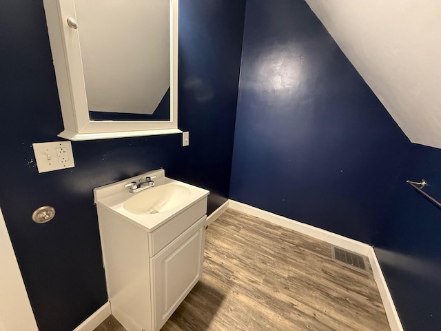 612 W Spring St, Saint Marys, OH 45885 - bathroom featuring vanity, baseboards, and wood finished floors