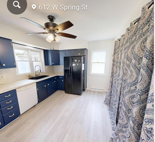 612 W Spring St, Saint Marys, OH 45885 - kitchen featuring a sink, white dishwasher, black fridge, blue cabinetry, and light wood-type flooring