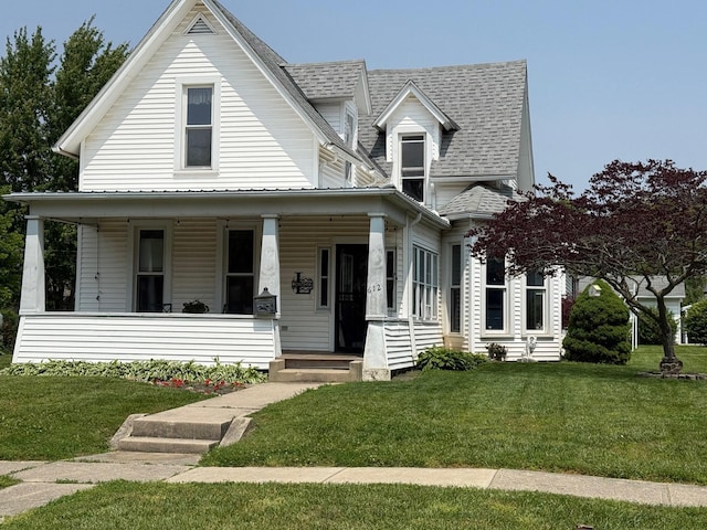 612 W Spring St, Saint Marys, OH 45885 - view of front of house with covered porch, a shingled roof, and a front lawn