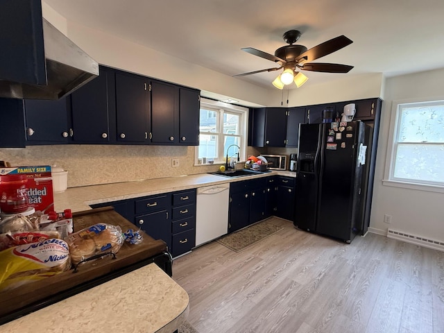 612 W Spring St, Saint Marys, OH 45885 - kitchen with black fridge, white dishwasher, a sink, stainless steel microwave, and under cabinet range hood
